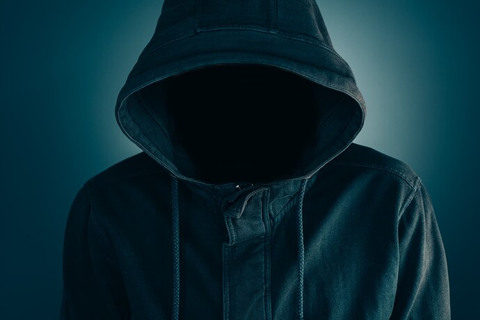 Person in a hood in the dark; a suspicious person