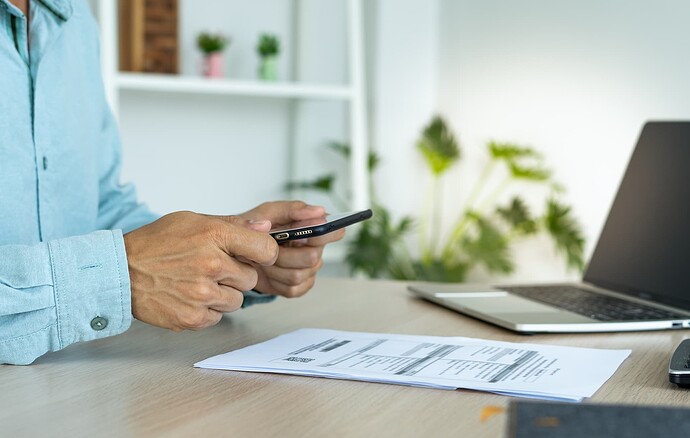 A man scanning his utility bill with a mobile phone