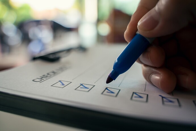 Ticking off a checklist on a clipboard