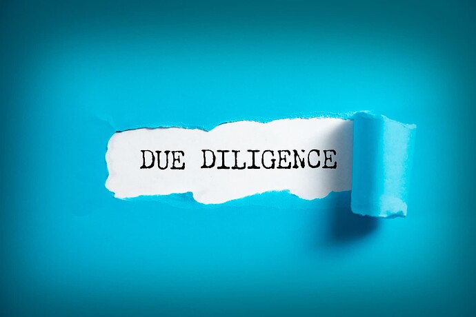 A blue background with a piece tearing away revealing the words "Due Diligence"