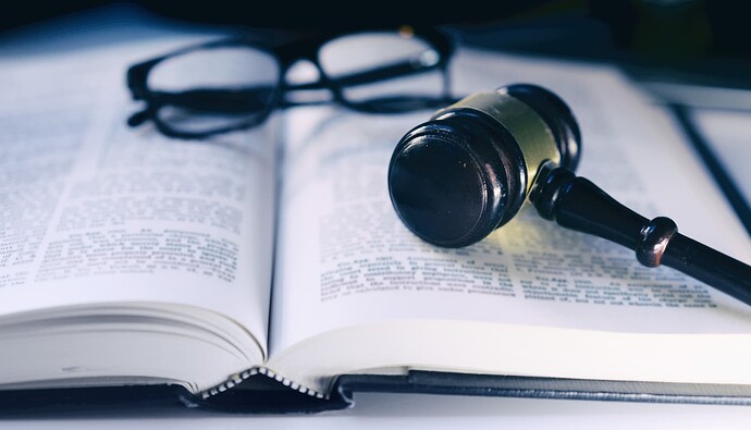 Gavel and glasses resting on an open book